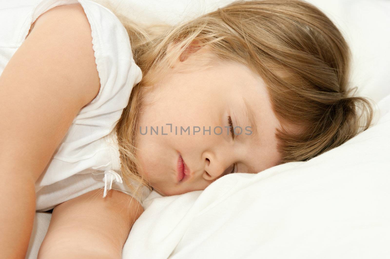 Sleeping little girl on bed