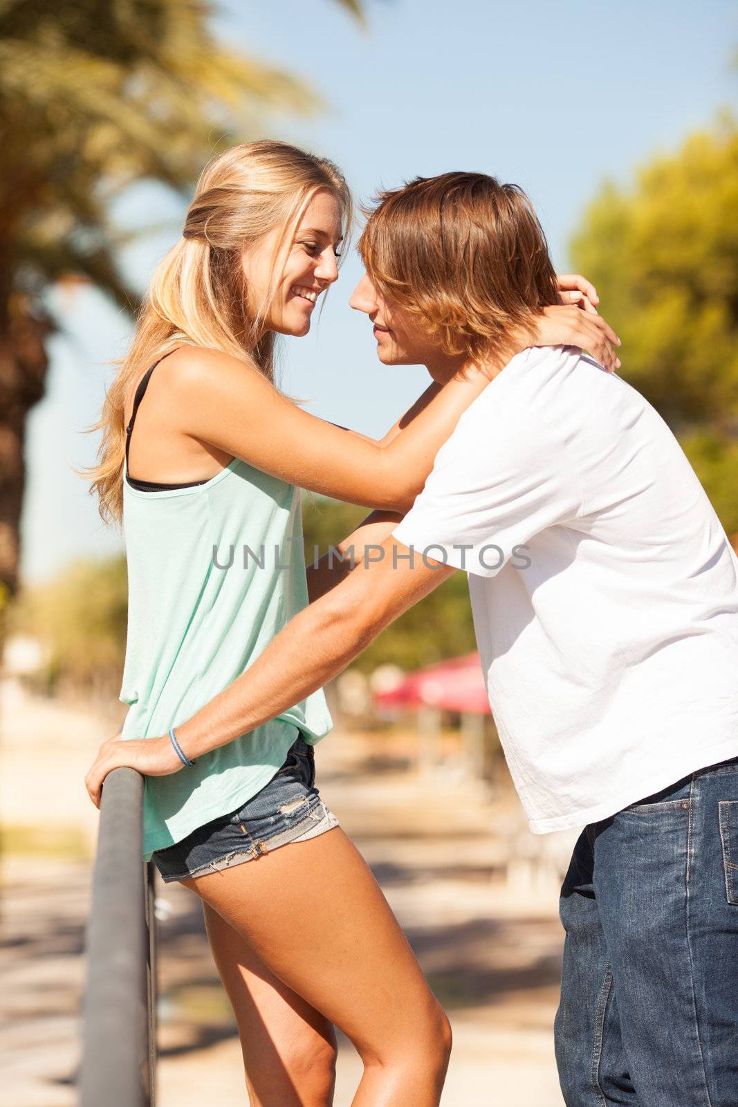 Young romantic beautiful couple enjoying on a walkside with threes