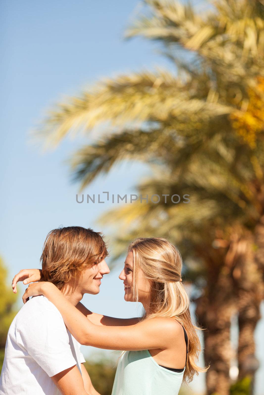 Young romantic beautiful couple enjoying on a walkside with threes