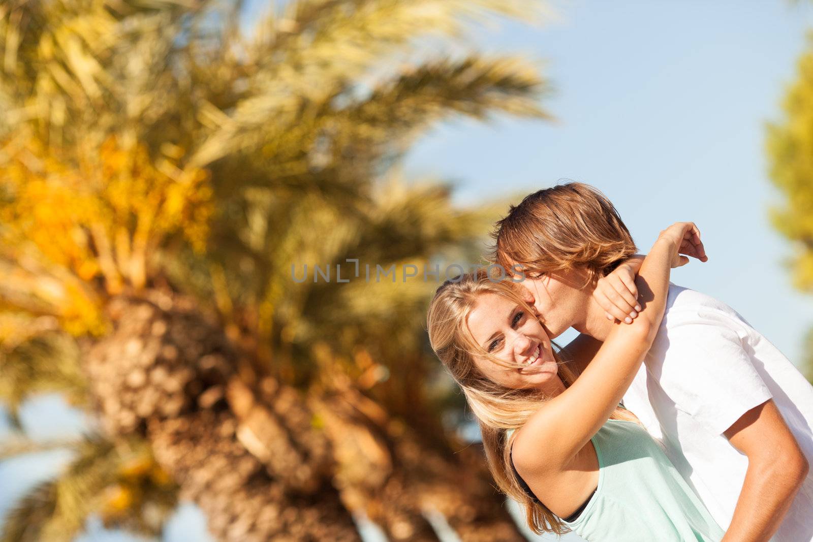 Young romantic beautiful couple enjoying on a walkside with threes