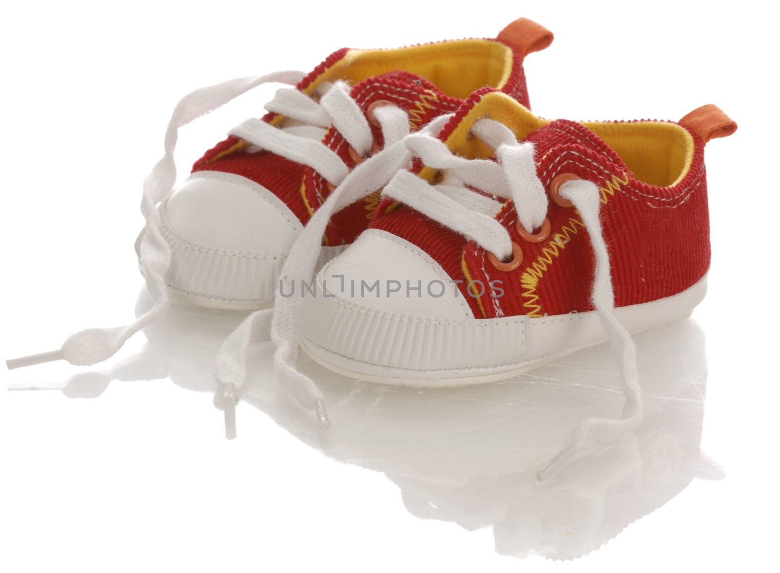 red baby on infant running shoes with laces untied