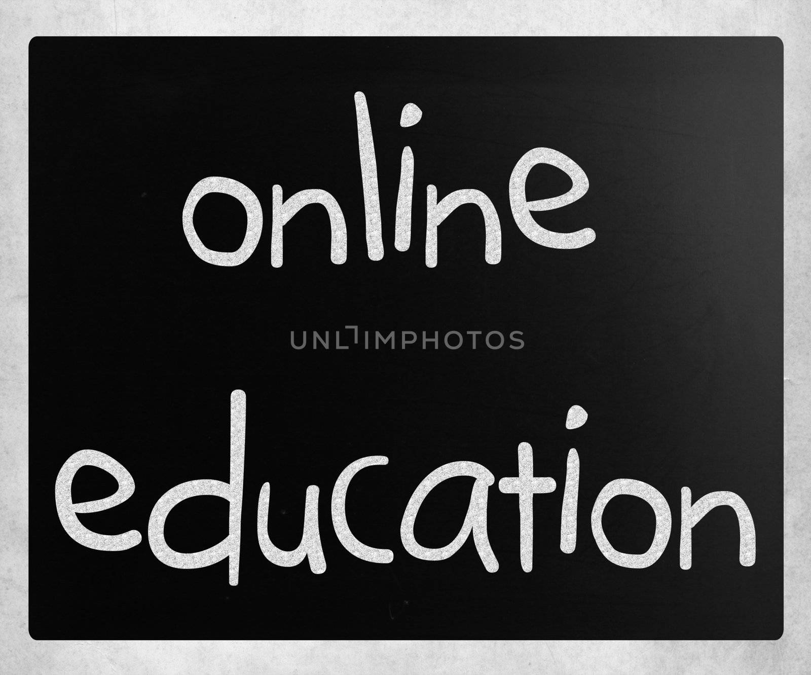 "Online education" handwritten with white chalk on a blackboard by nenov