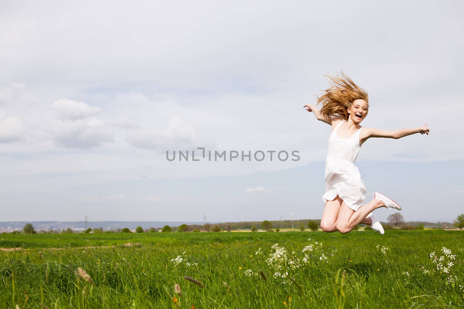 beautiful blonde woman outdoor in summer happy