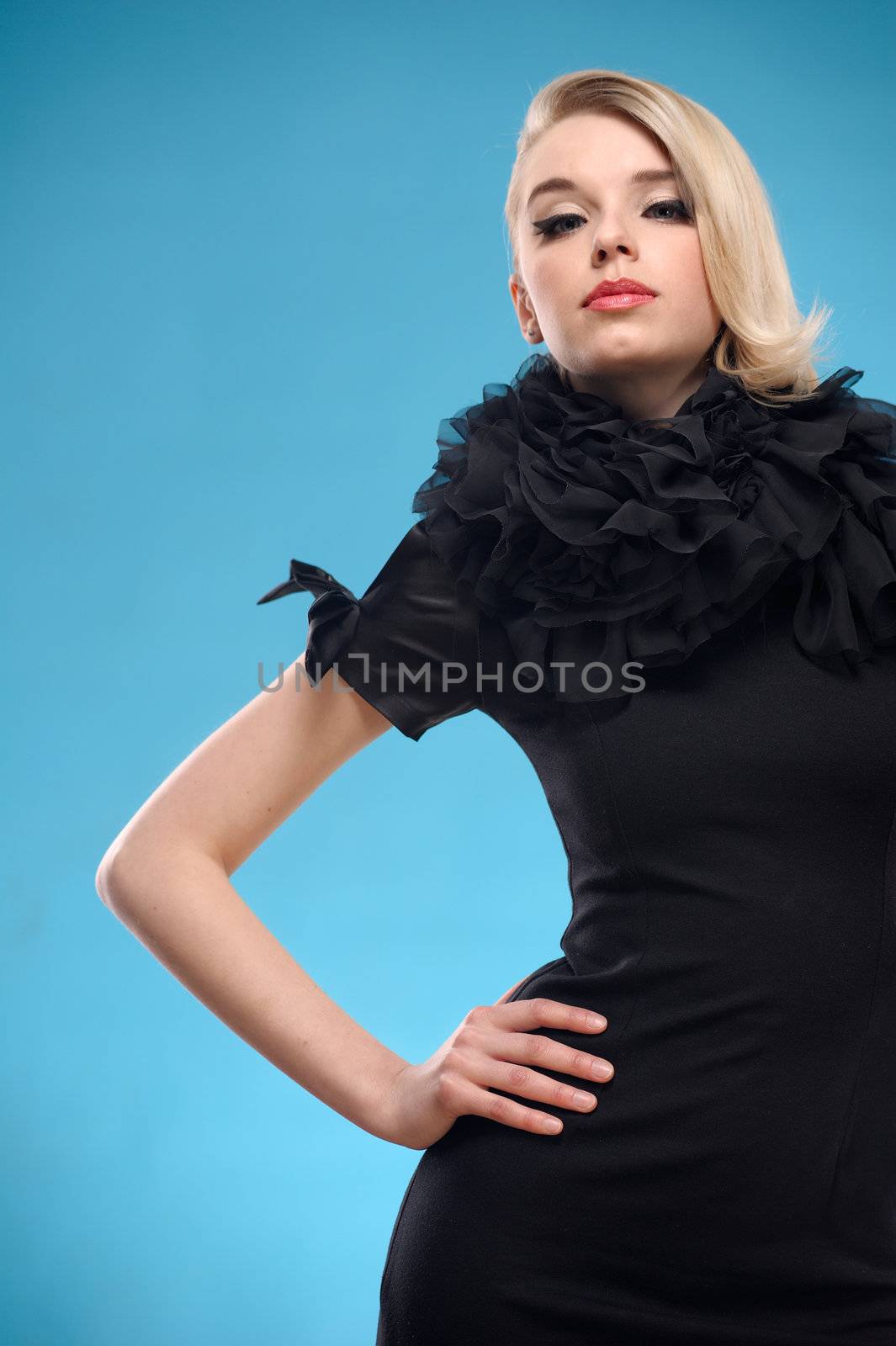 Beautiful blond woman with elegant black formal dress. Over blue background