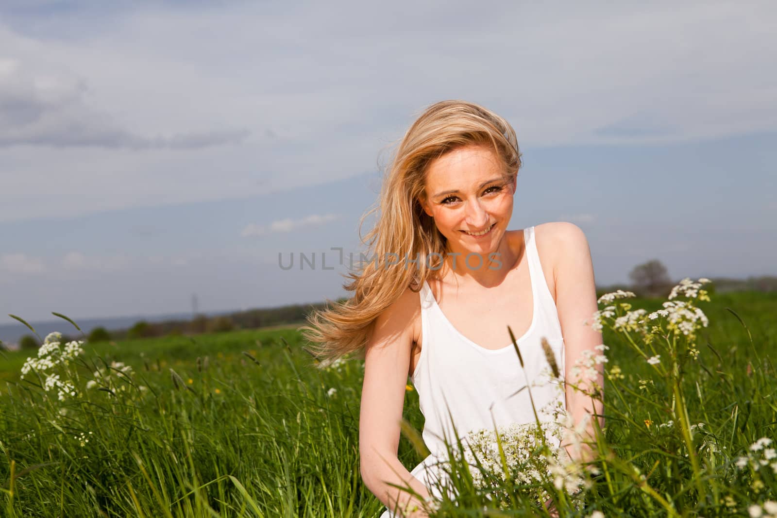 beautiful blonde woman outdoor in summer happy