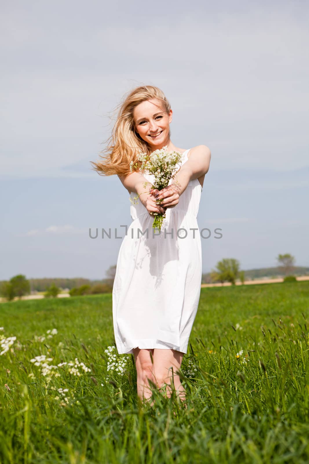 beautiful blonde woman outdoor in summer happy