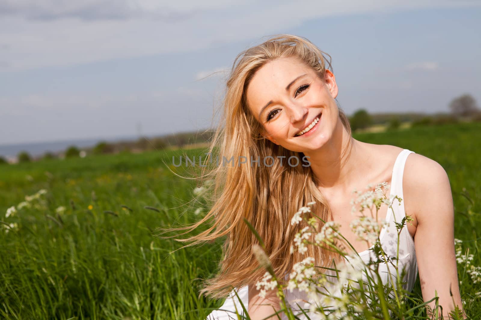 beautiful blonde woman outdoor in summer happy