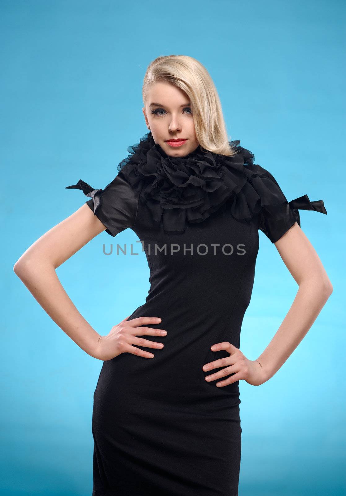 Beautiful blond woman with elegant black formal dress. Over blue background