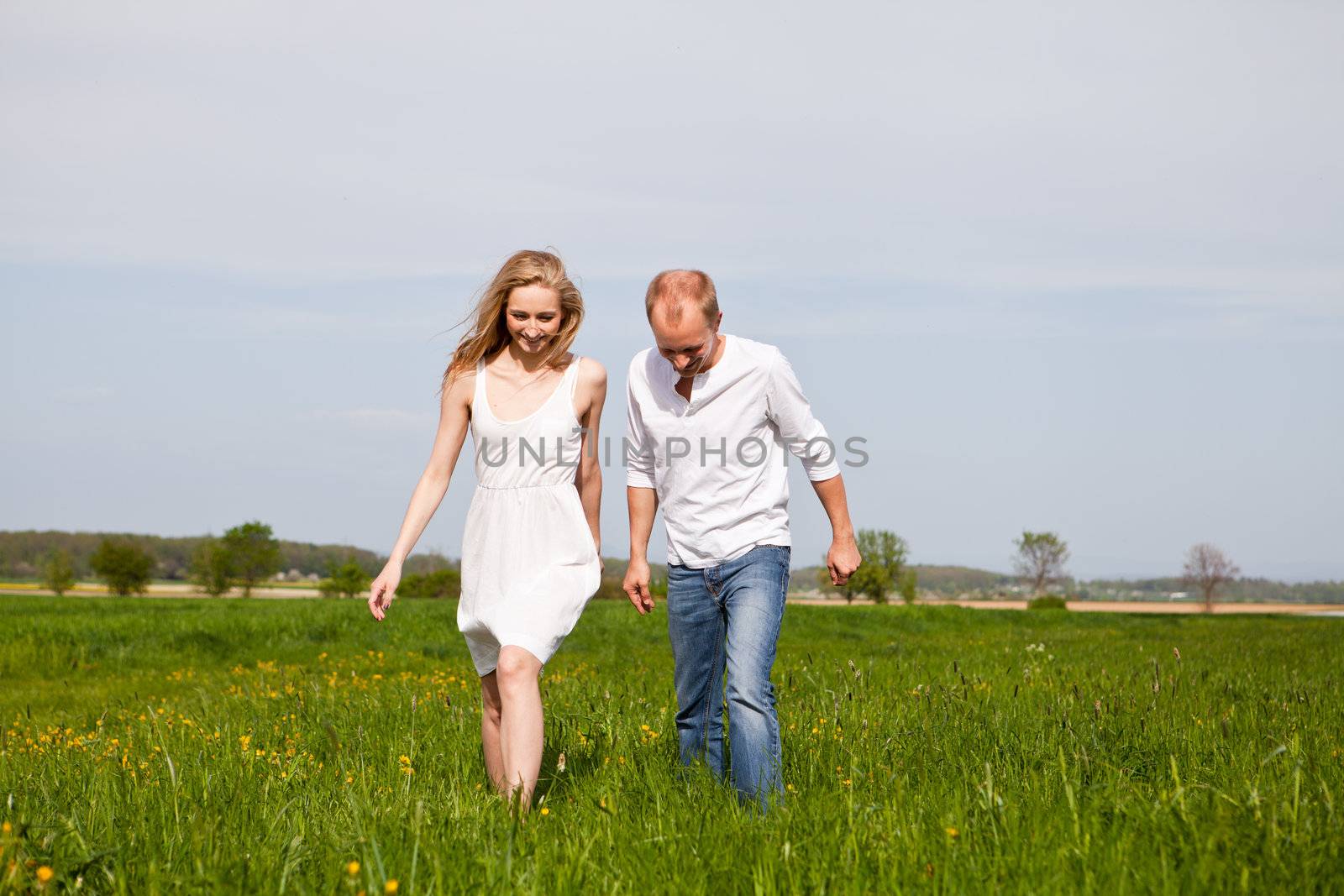 young happy couple have fun in summer outdoor in nature