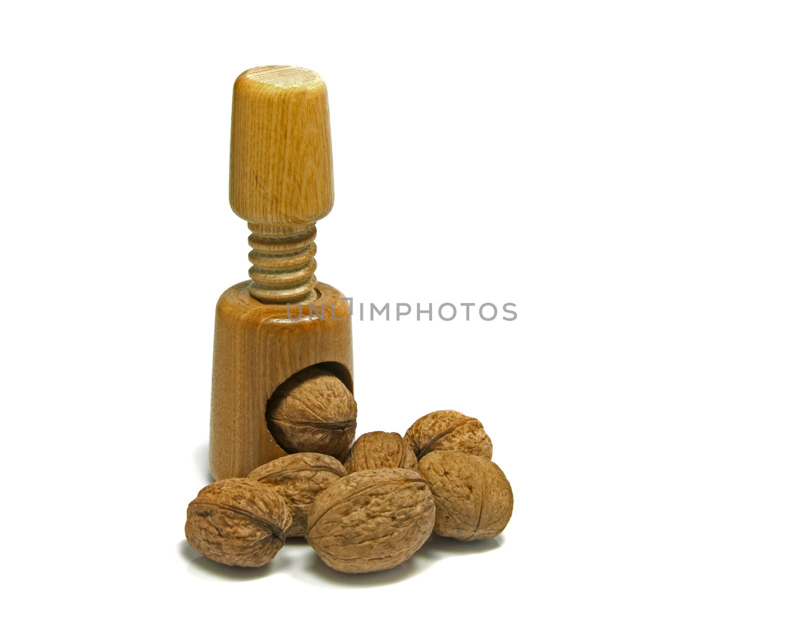 wooden nutcracker isoalted on white with walnuts