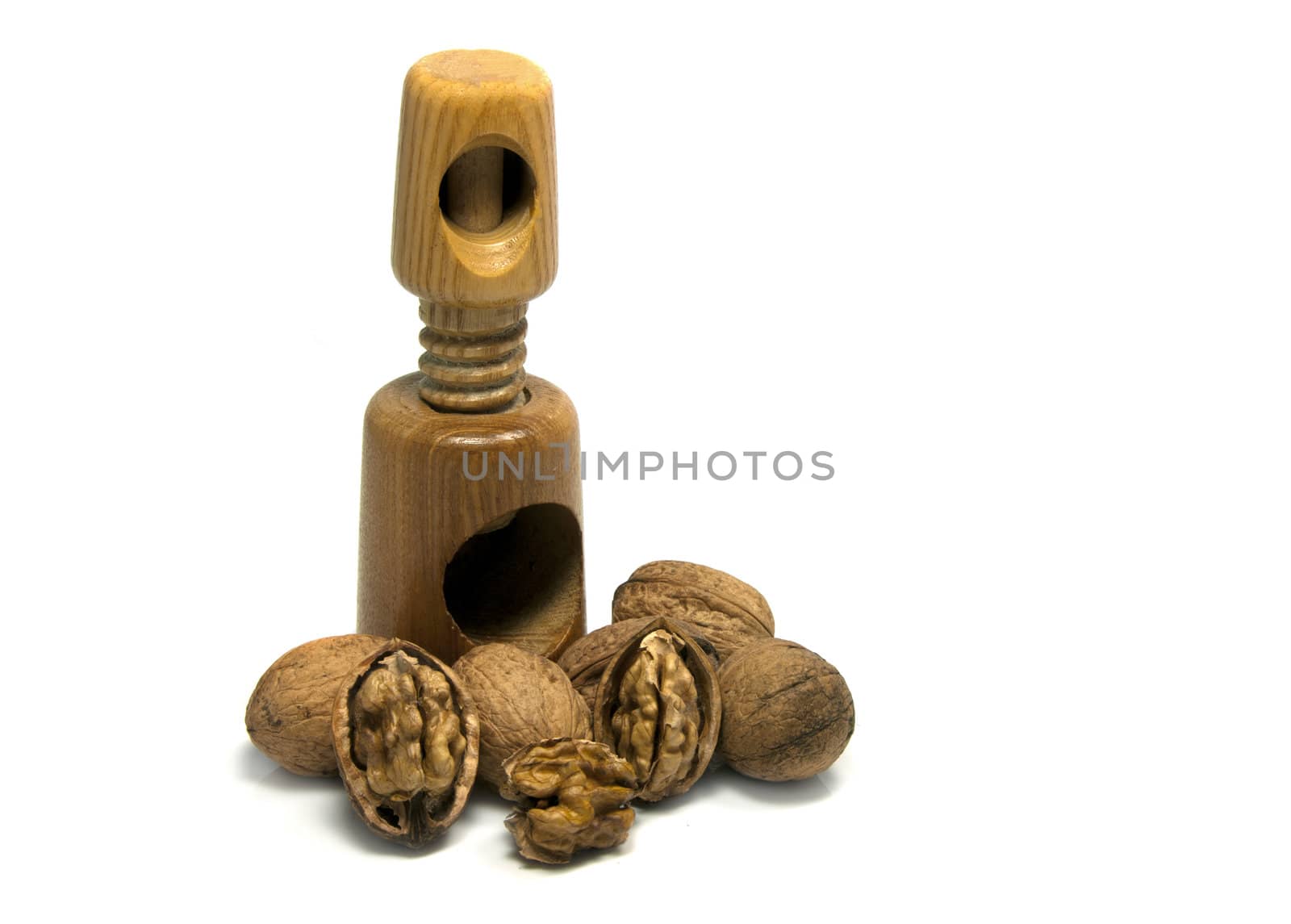 wooden nutcracker isoalted on white with walnuts