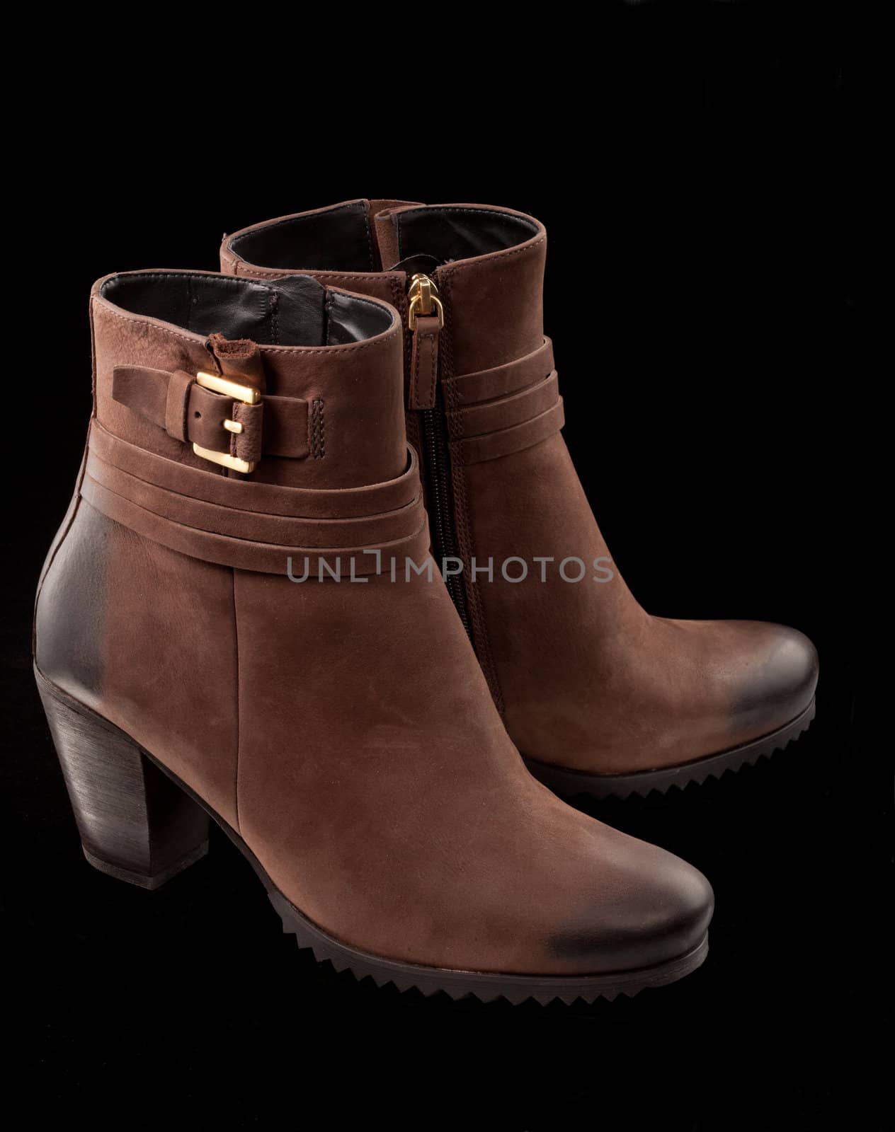 modern female ankle boots over black background