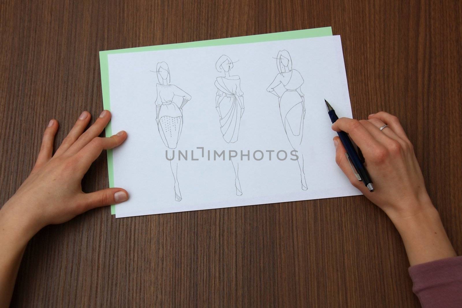 designer assessing fashion drawings by mturhanlar