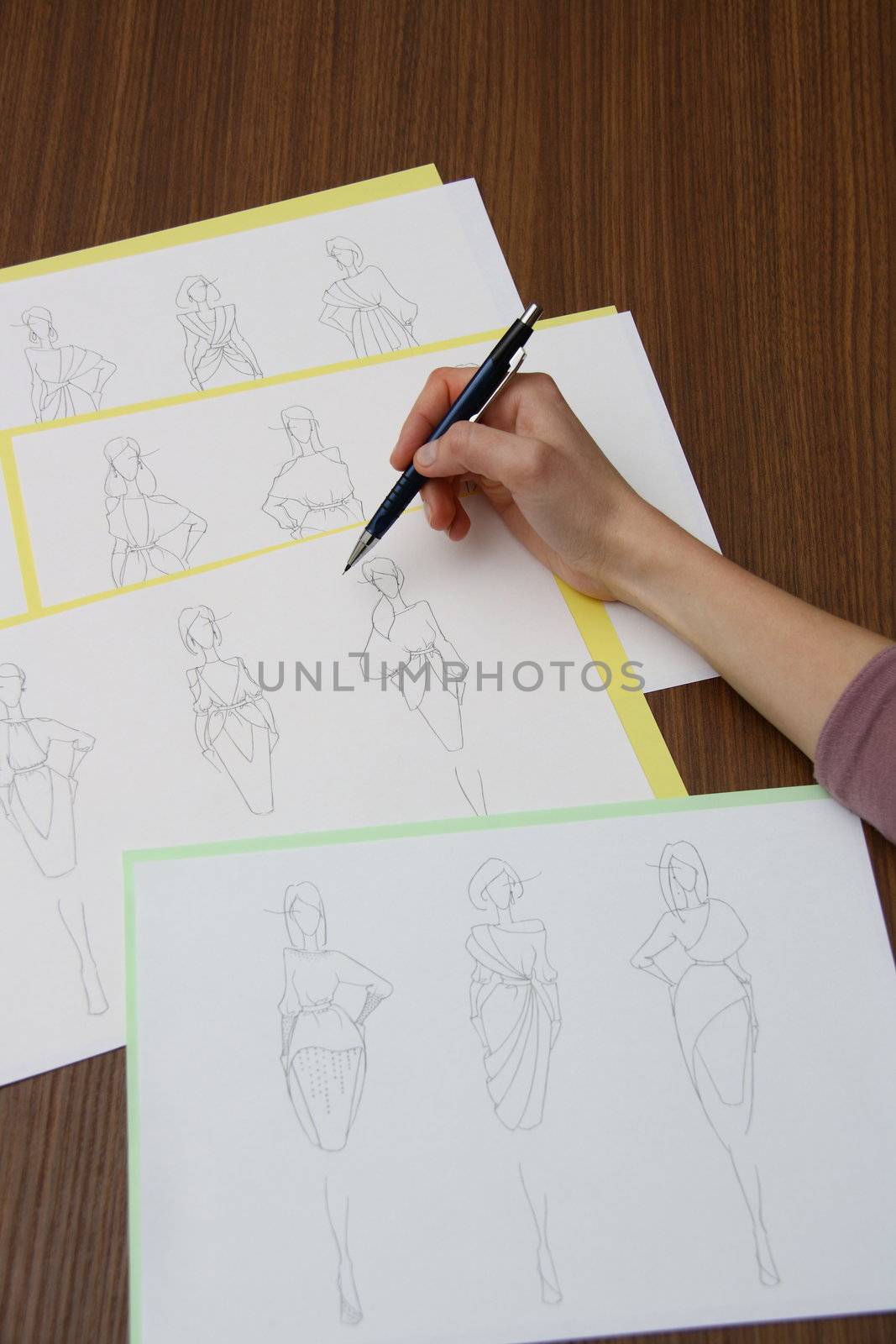 designer assessing fashion drawings by mturhanlar