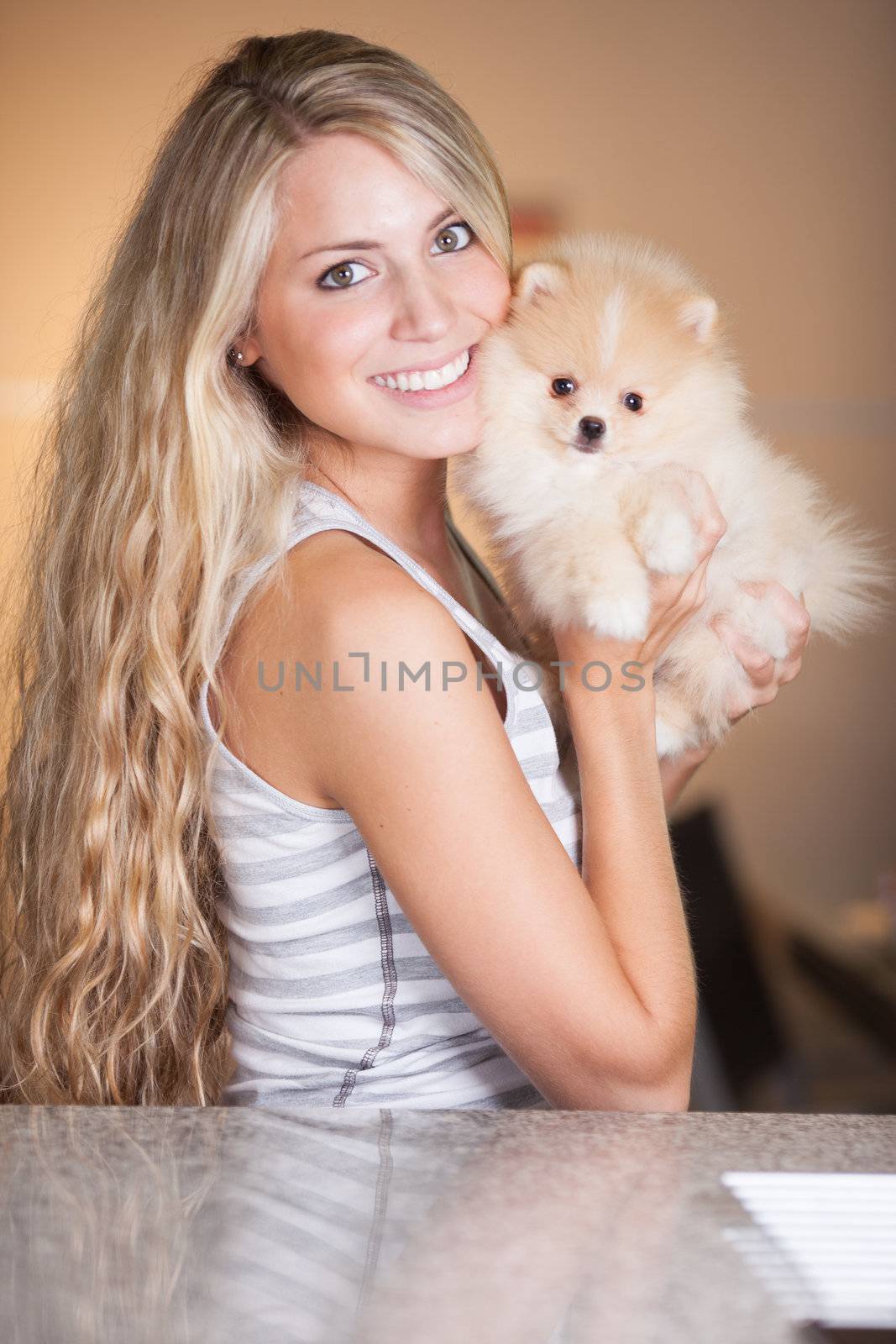 young woman playing with her tinny dog at home
