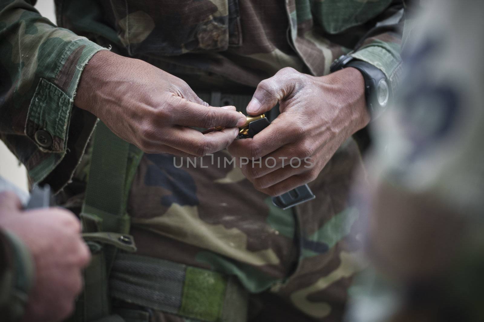 Soldier while charging a gun