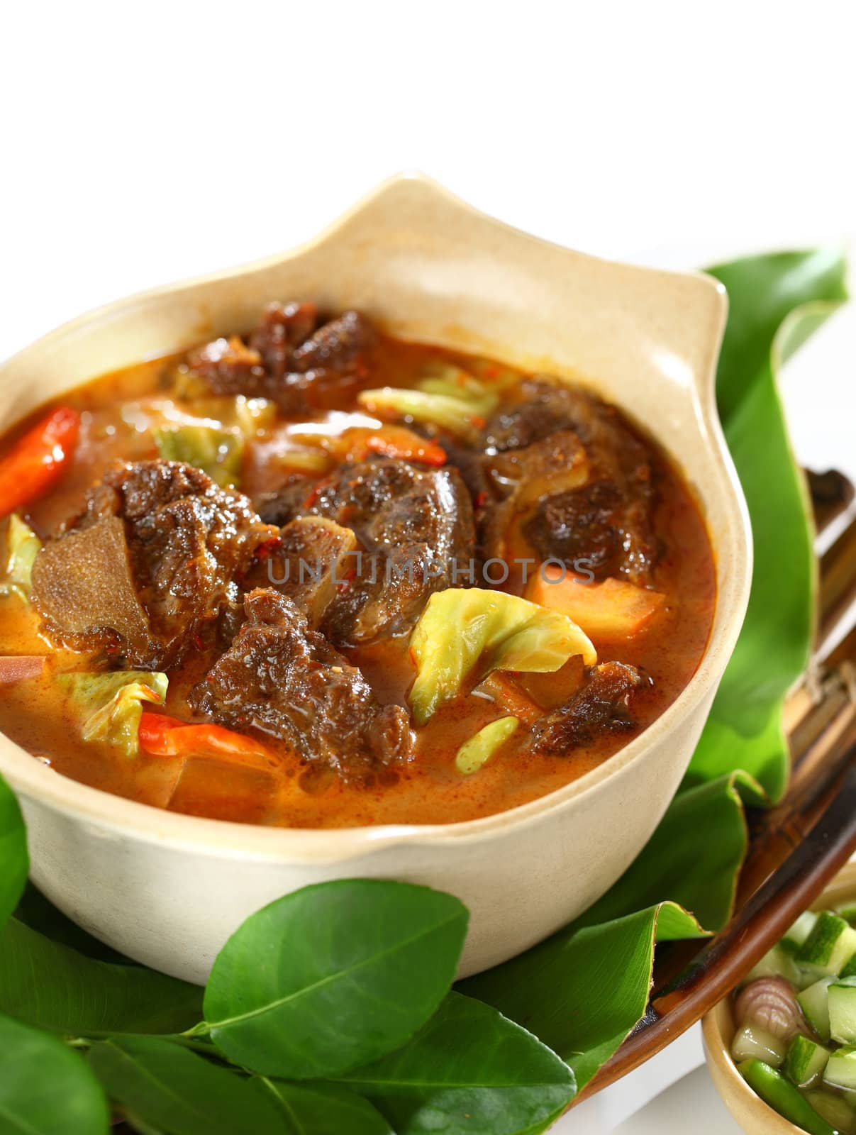 Tongseng served with rice. A Javanese style spicy curry stew with goat meat with bone still attached.