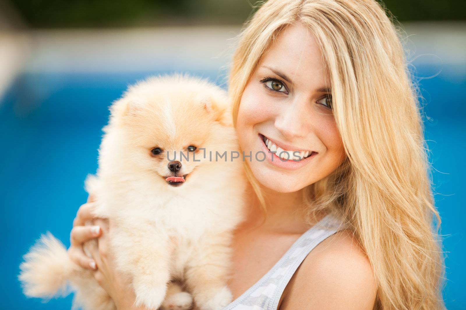 young woman playing with her tinny dog at home