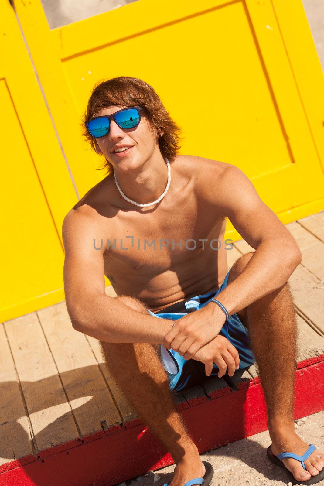 handsome man watching the sea on a lifeguard house by Lcrespi