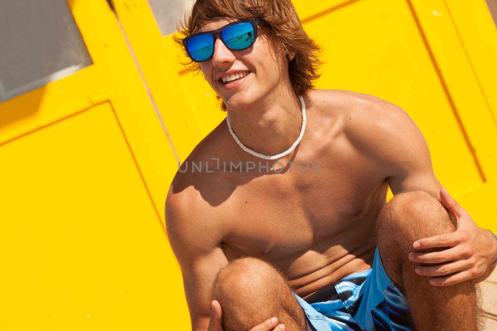 handsome man watching the sea on a lifeguard house