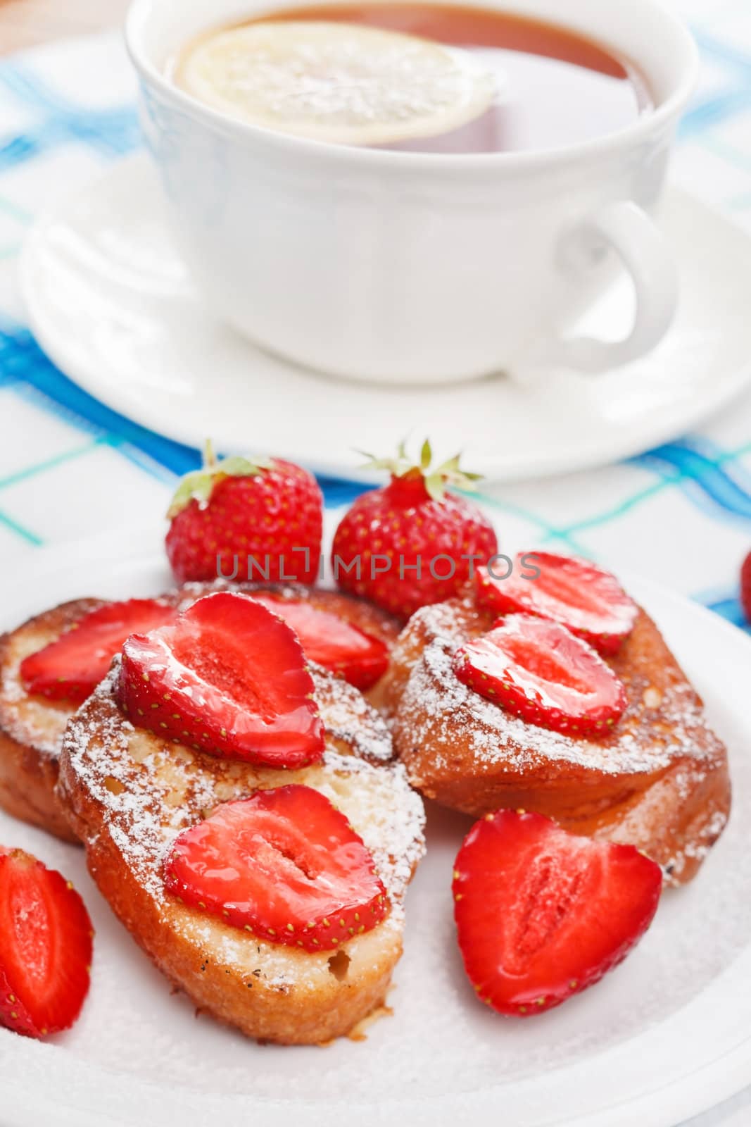 French toasts with powdered sugar and a strawberry by shebeko