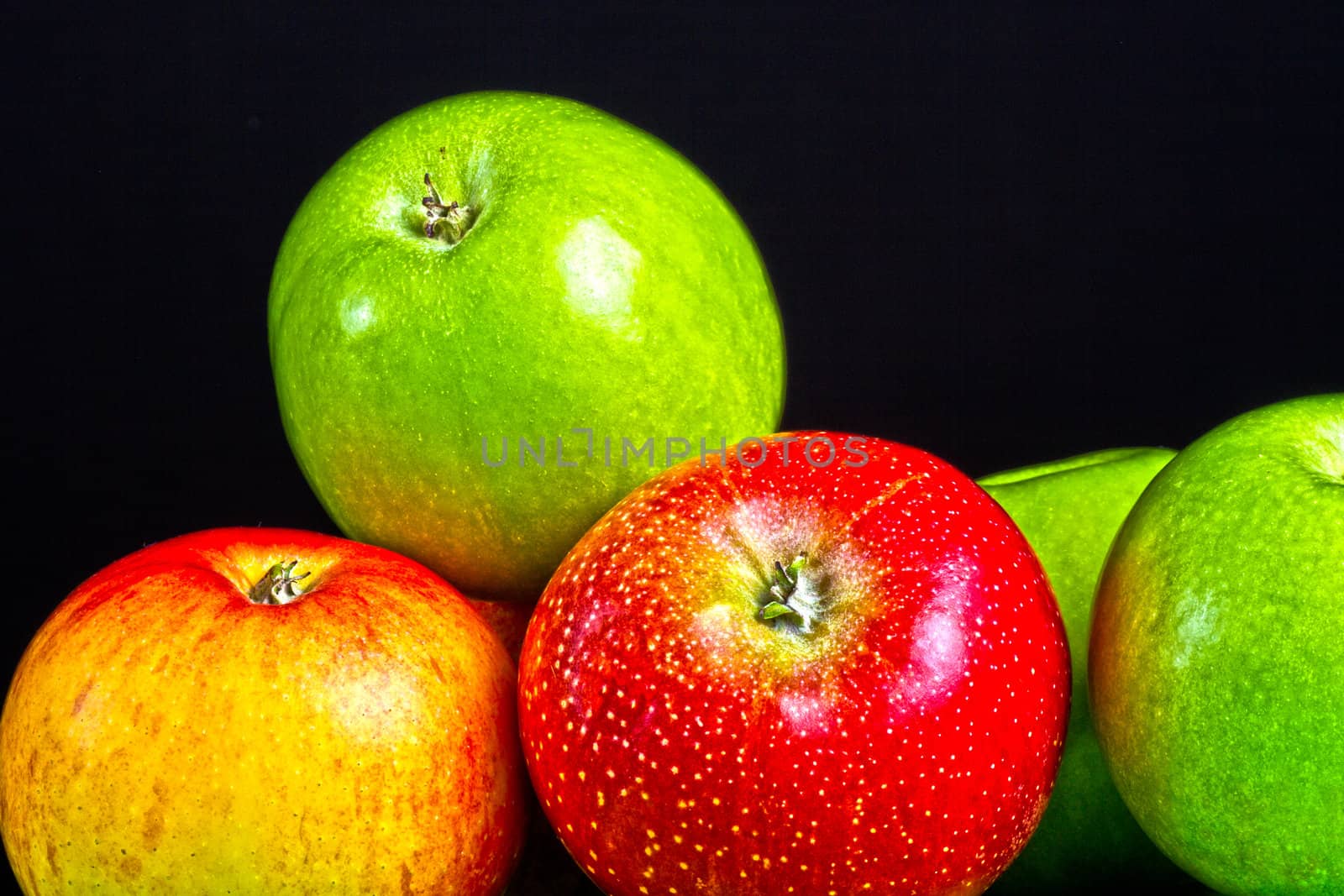 Apples in a row on black backround