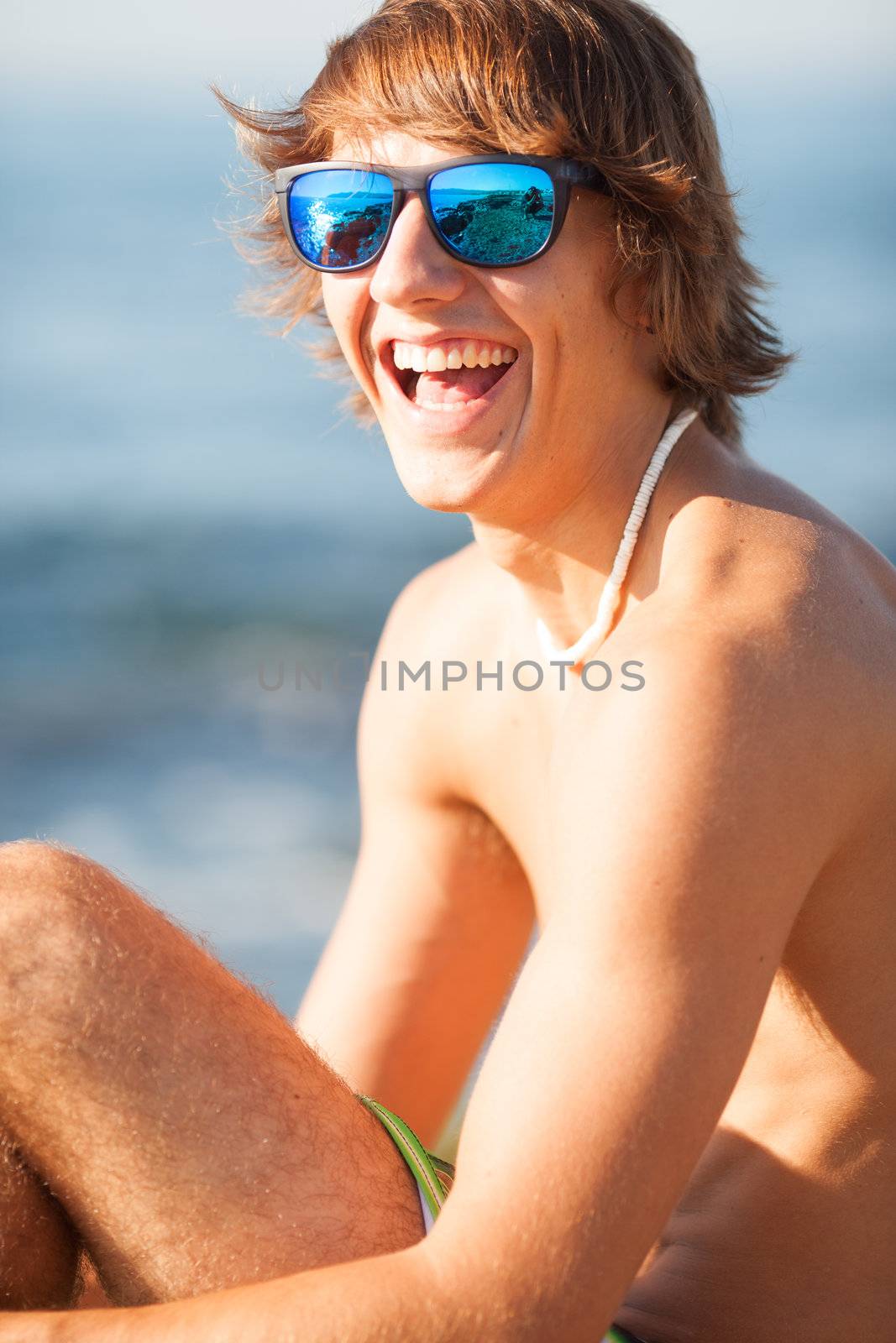 young healthy beautiful men portrait laughing on the beach by Lcrespi