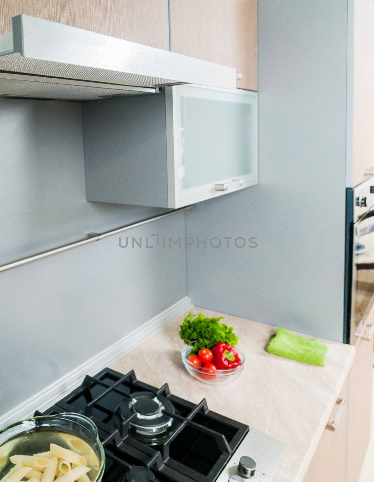 Clouseup range hood - detail of a modern kitchen. Vertical view