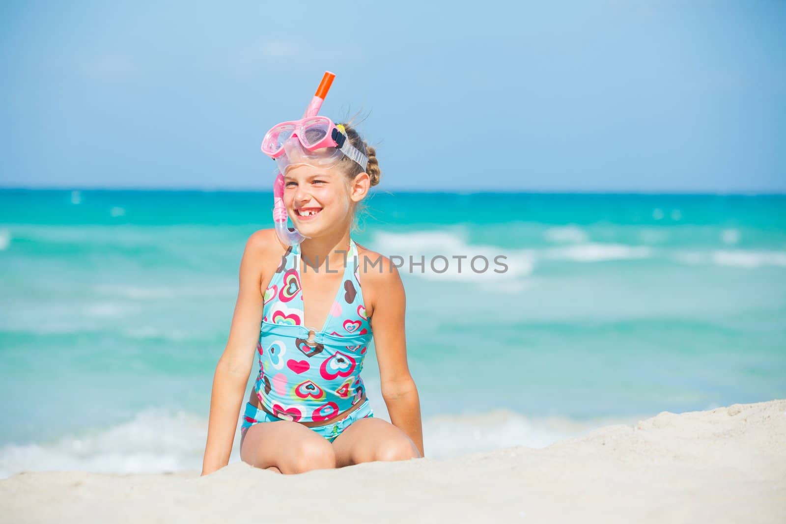 Portrait of a cute girl wearing a mask for diving background of the sea