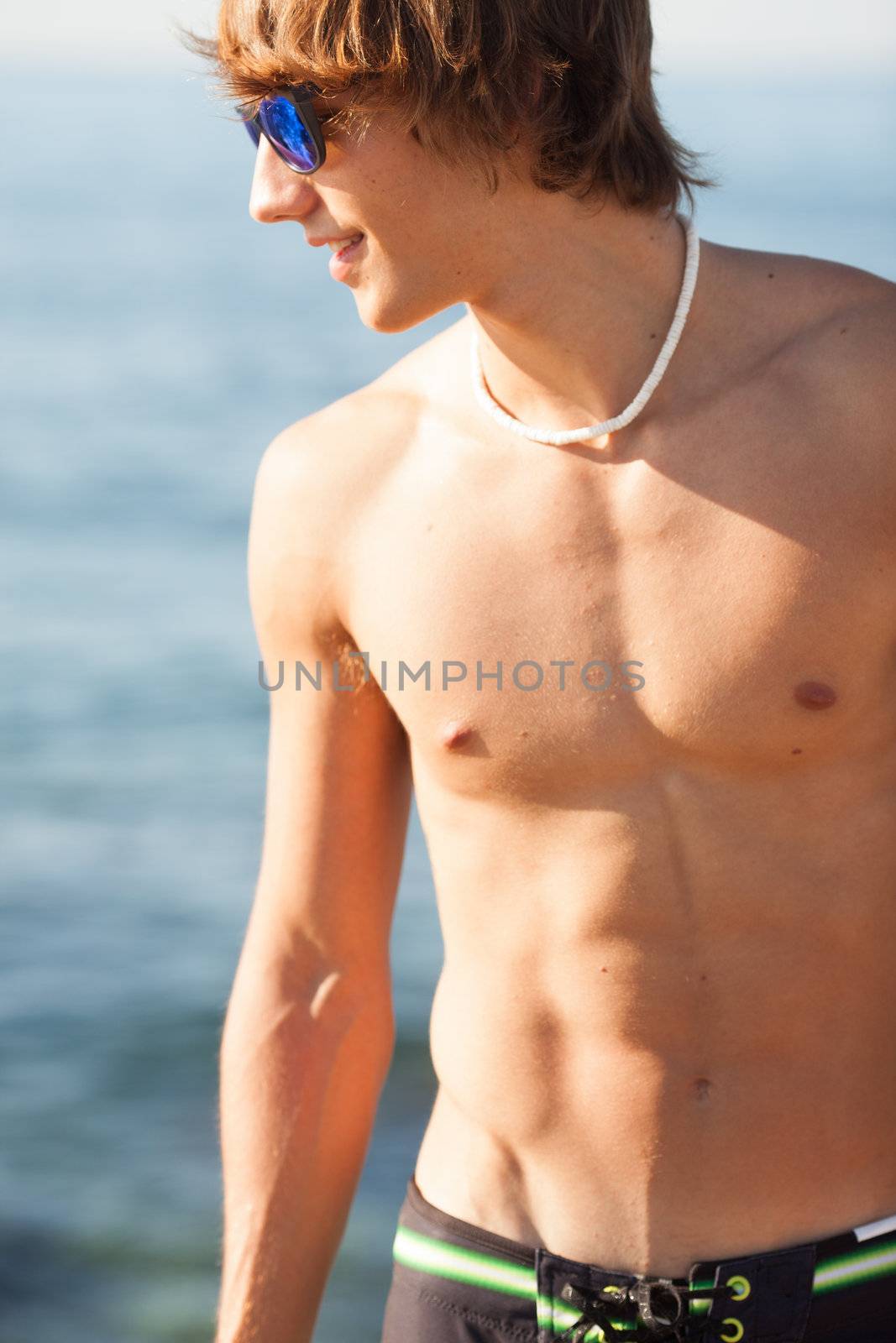 young healthy beautiful men portrait laughing on the beach by Lcrespi