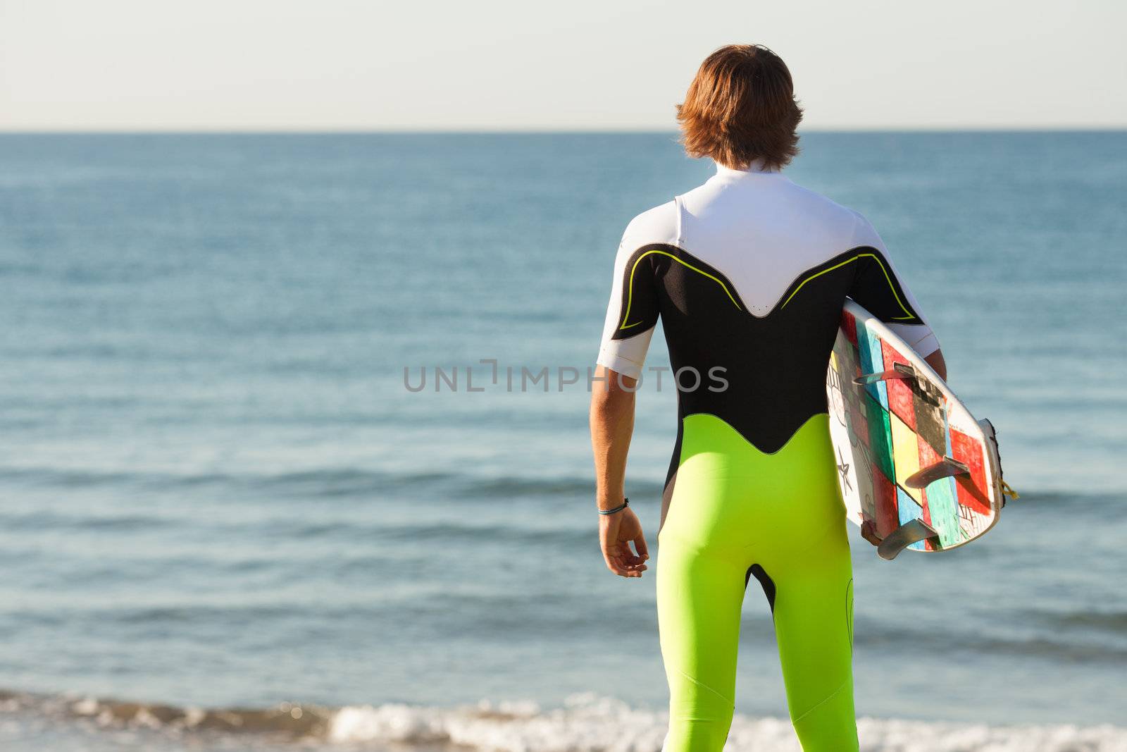 young surfer about to get into the sea