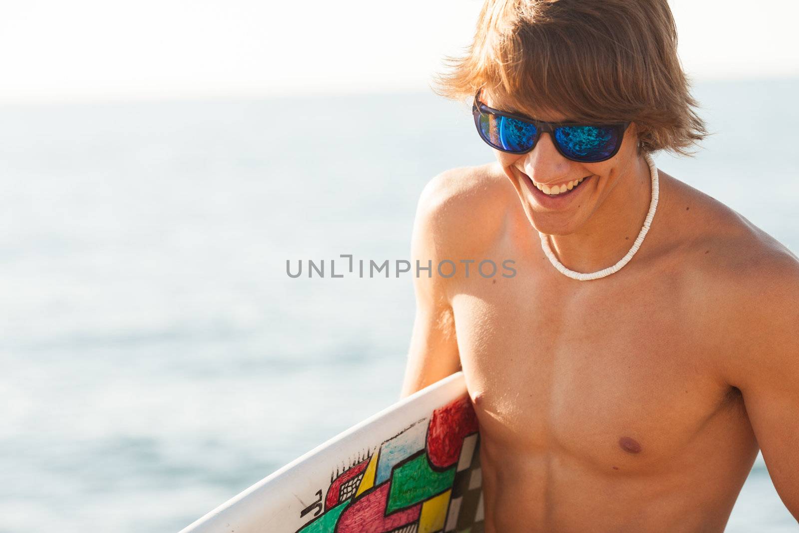 young surfer about to get into the sea by Lcrespi