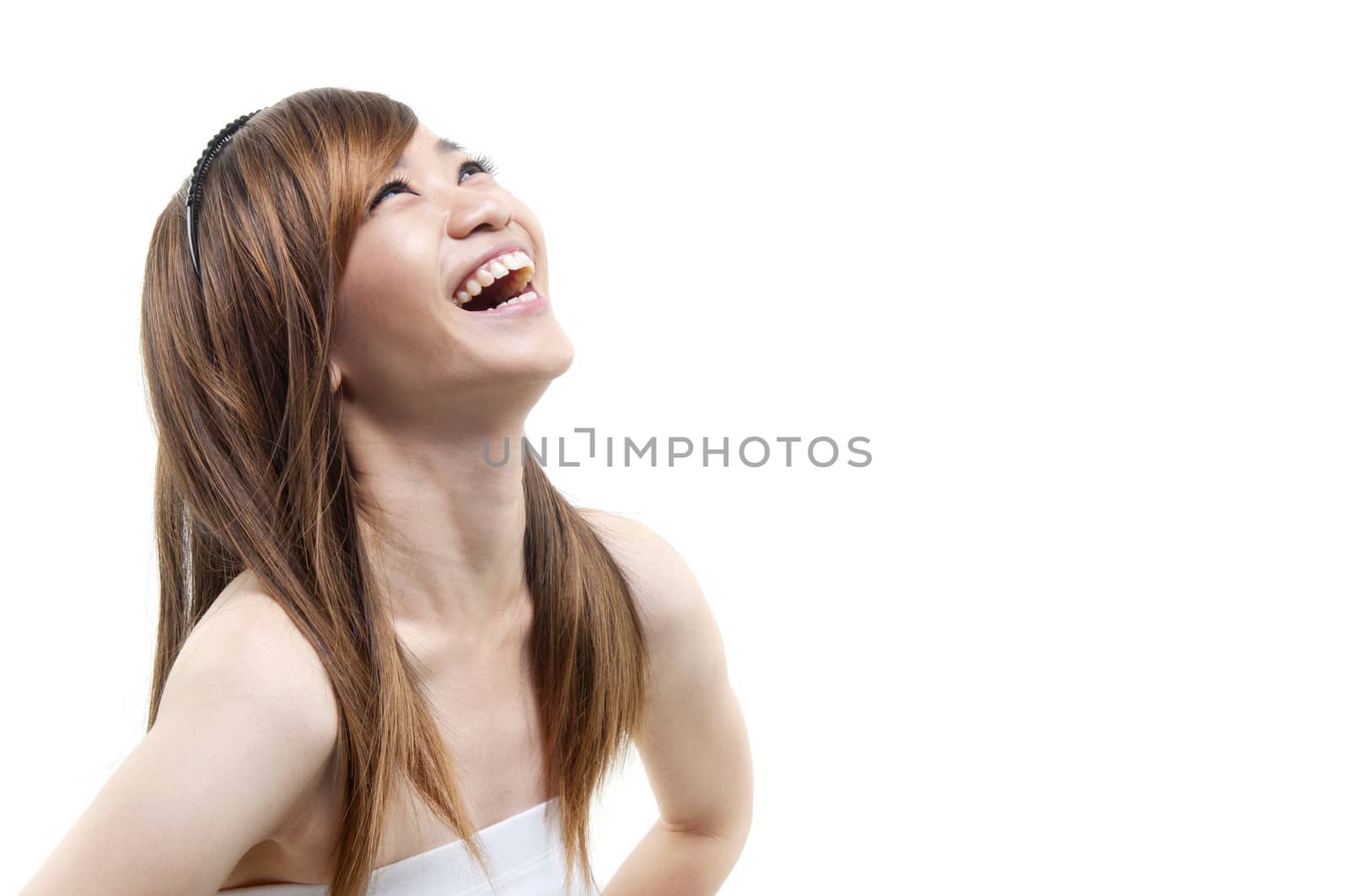 Laughing Asian woman looking up on white background