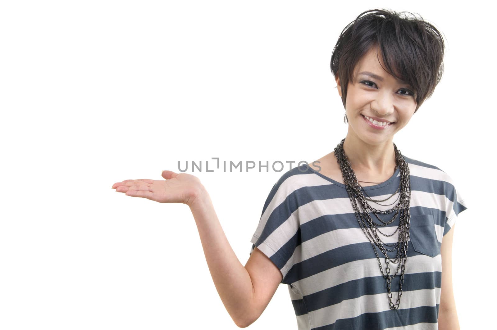 Happy cheerful beautiful Asian young woman holding her hand out and showing copy space for your product.