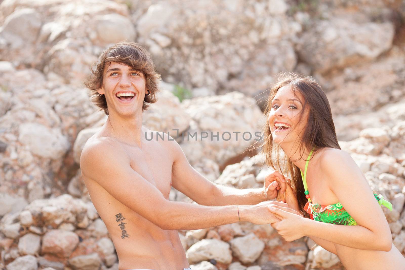 beautiful young couple having fun on the beach by Lcrespi