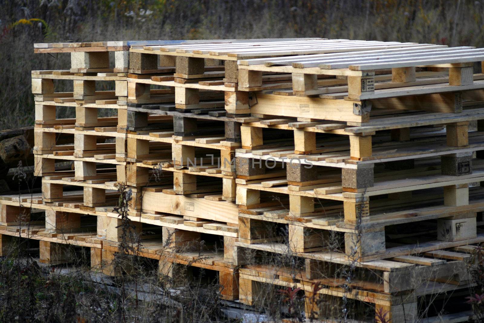 stacked pallets in a meadow