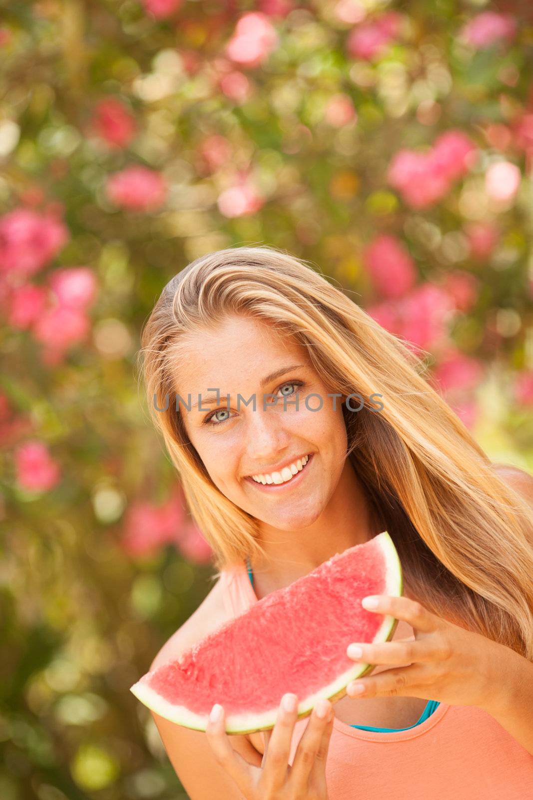 Portrait of a beautiful young woman eating watermelon by Lcrespi