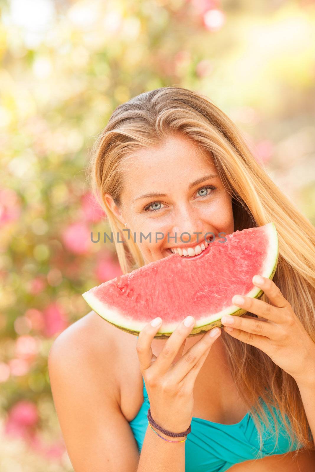 Portrait of a beautiful young woman eating watermelon