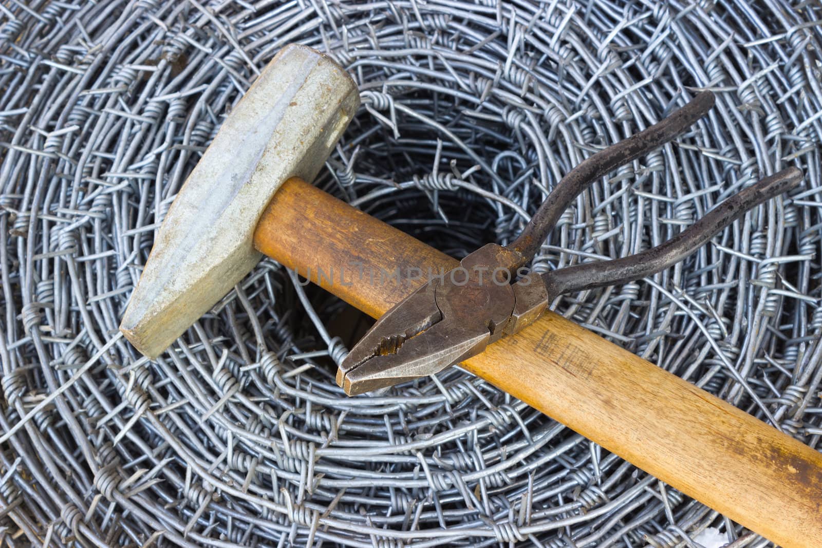Bay of barbed wire, a hammer and pliers