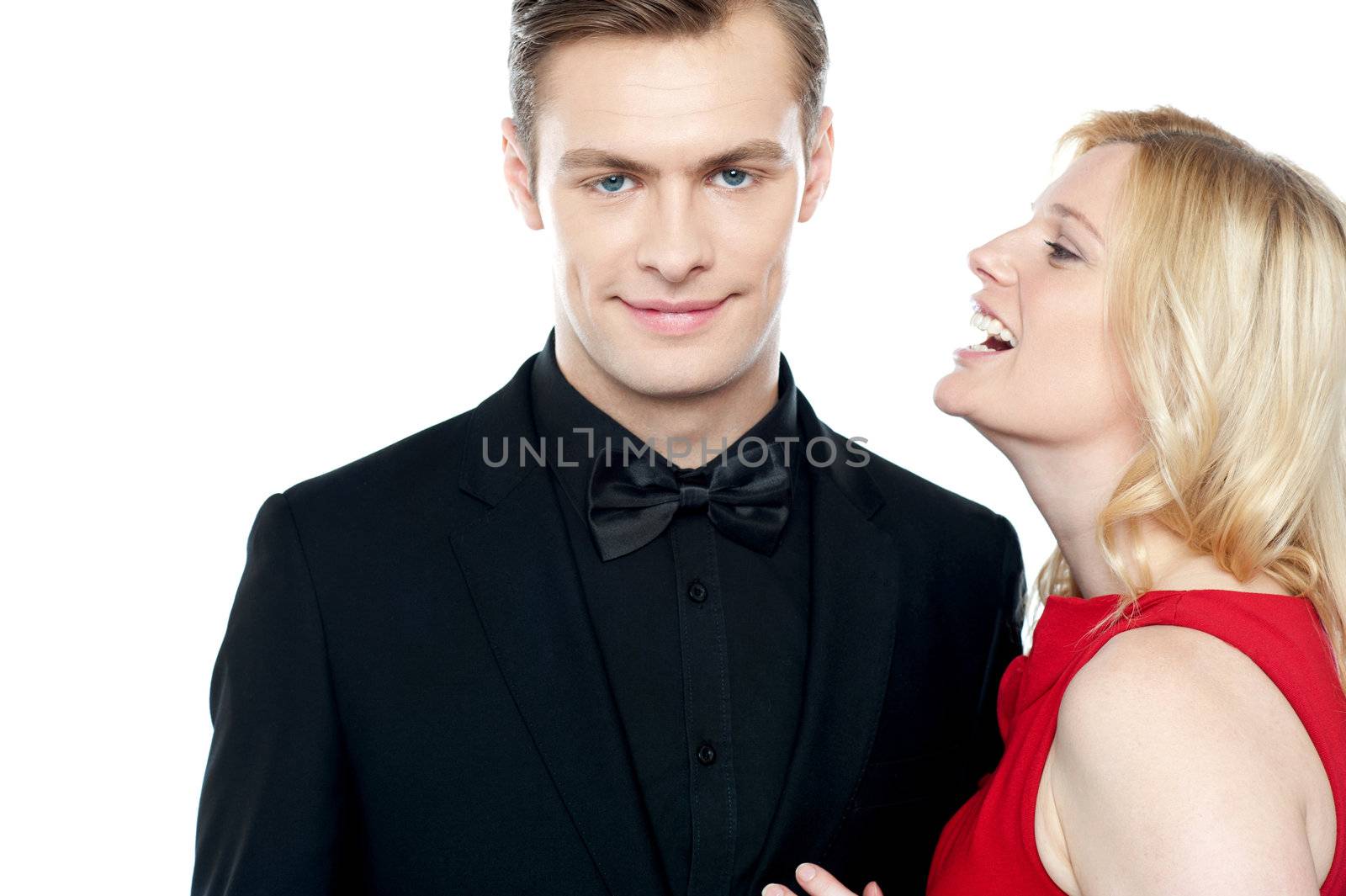 Woman whispering something to her sweetheart on white background