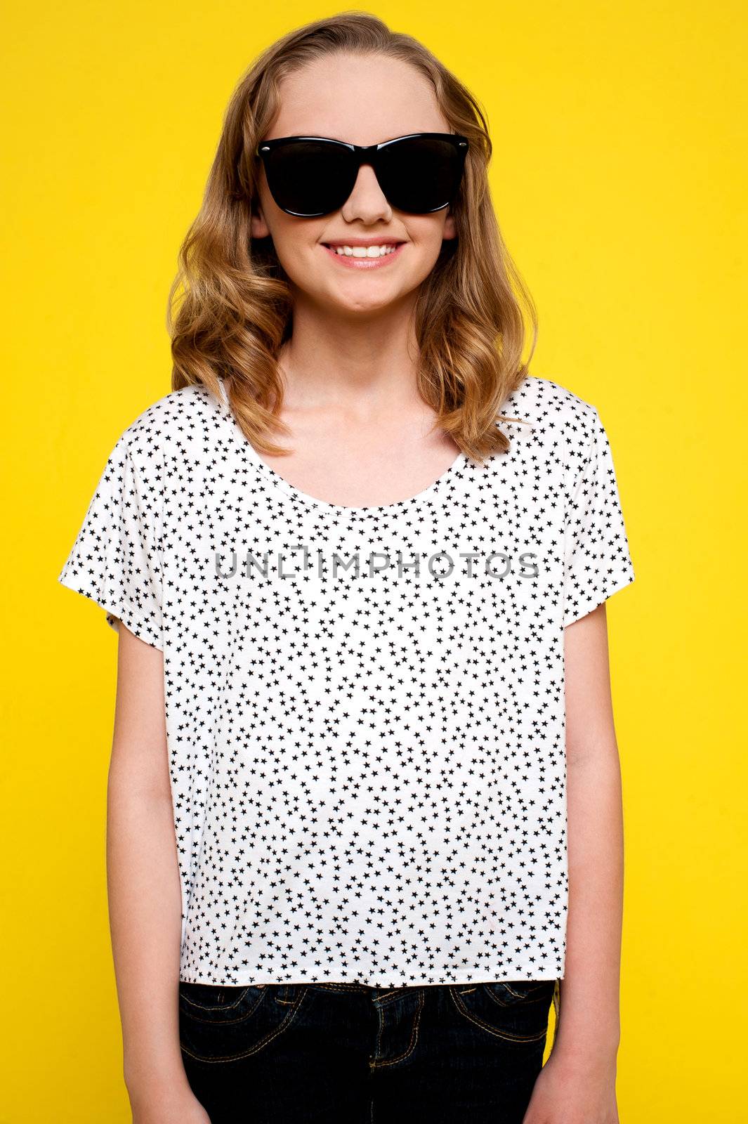 Beautiful girl posing in lack goggles isolated over yellow