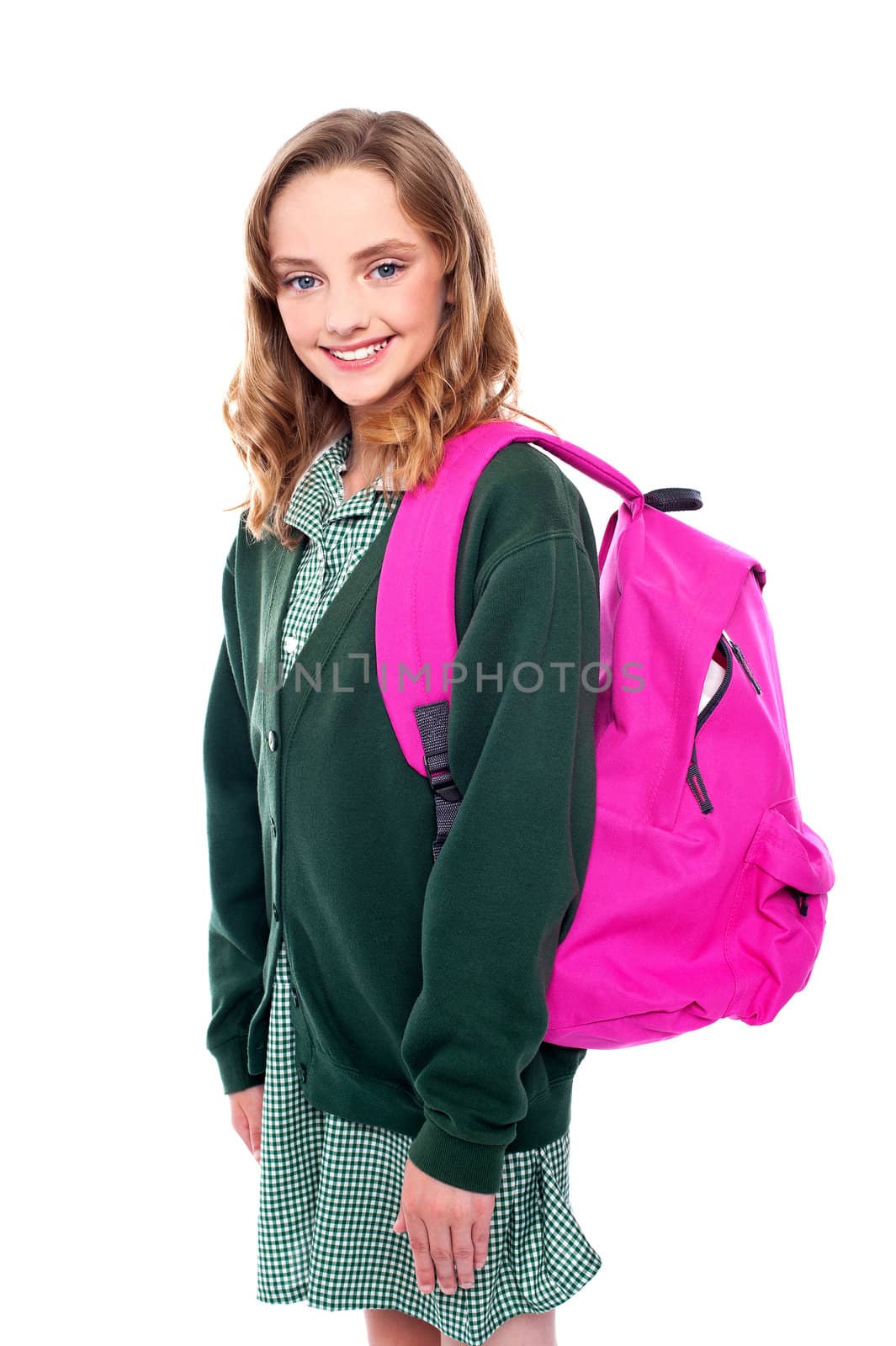 Studio shot of school girl carrying bag on shoulders. All on white background