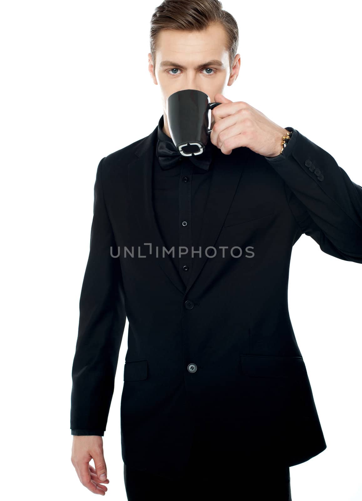 Smart young man drinking coffee in black cup over white background