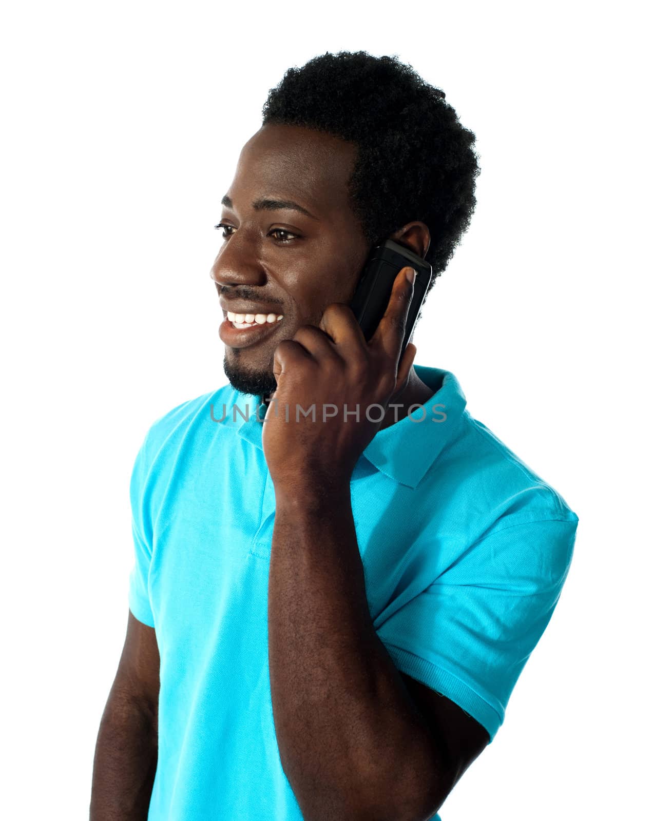 African guy communicating via cellphone and looking away.