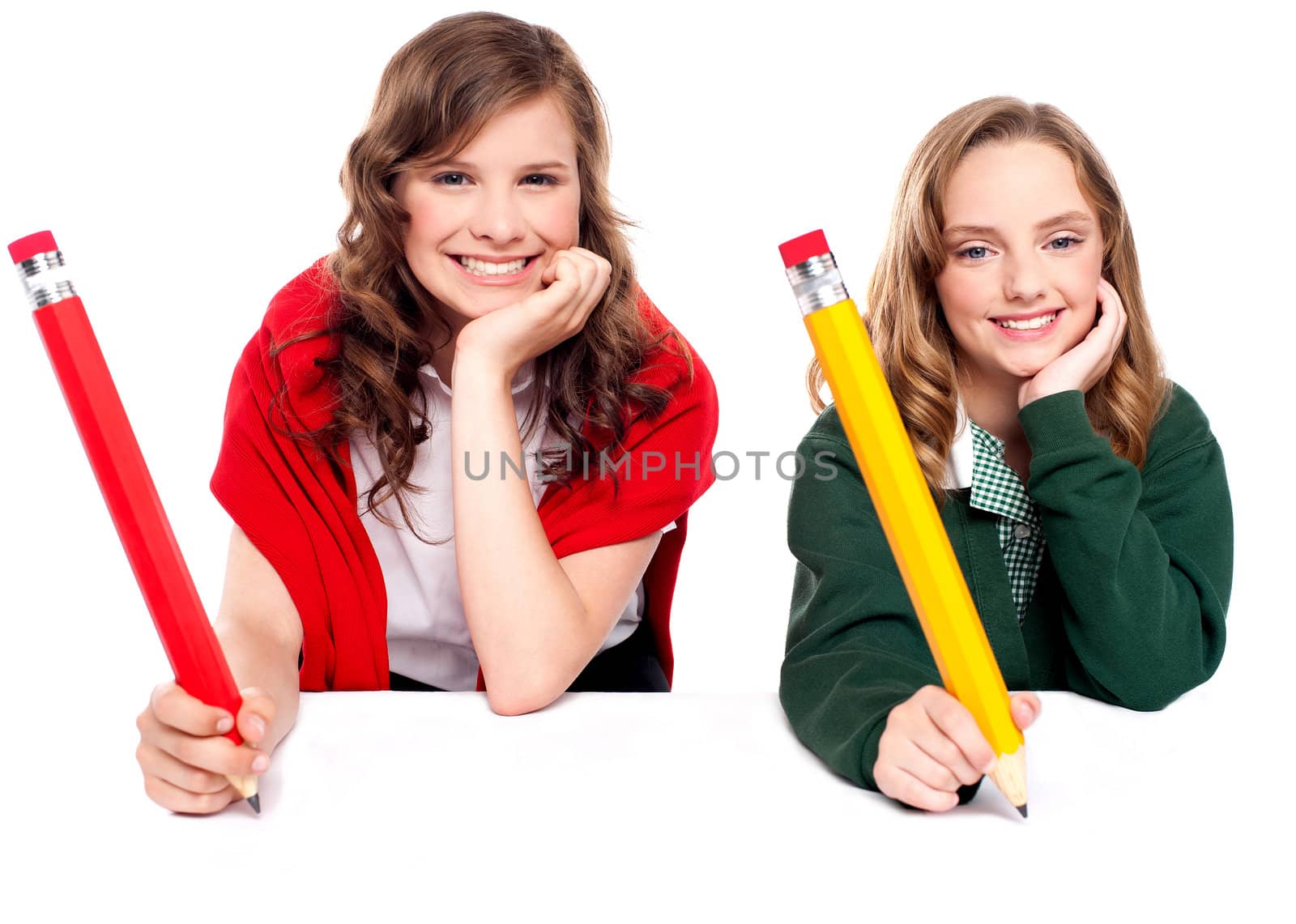 Beautiful schoolgirls with hands on cheek writing on white surface