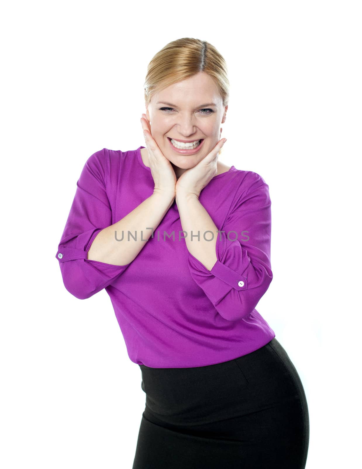 Excited woman posing with hands on chin isolated over white background