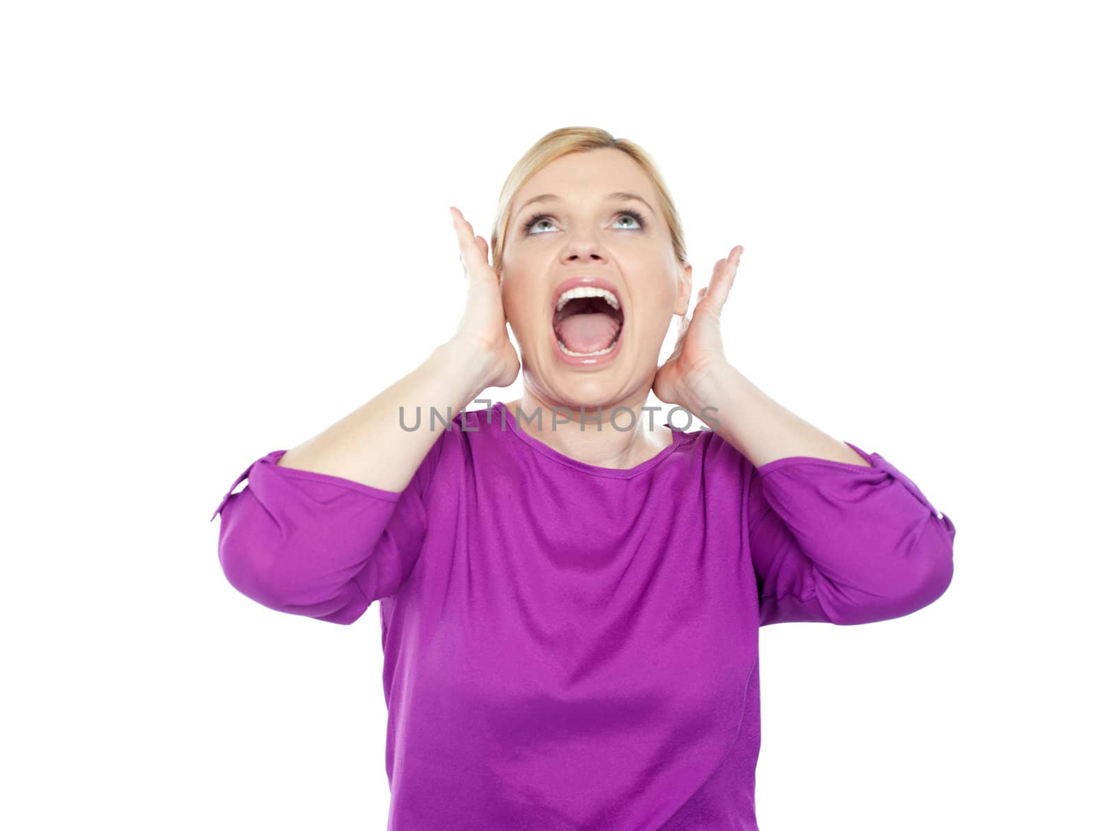 Woman shouting with hands on ears and looking upwards
