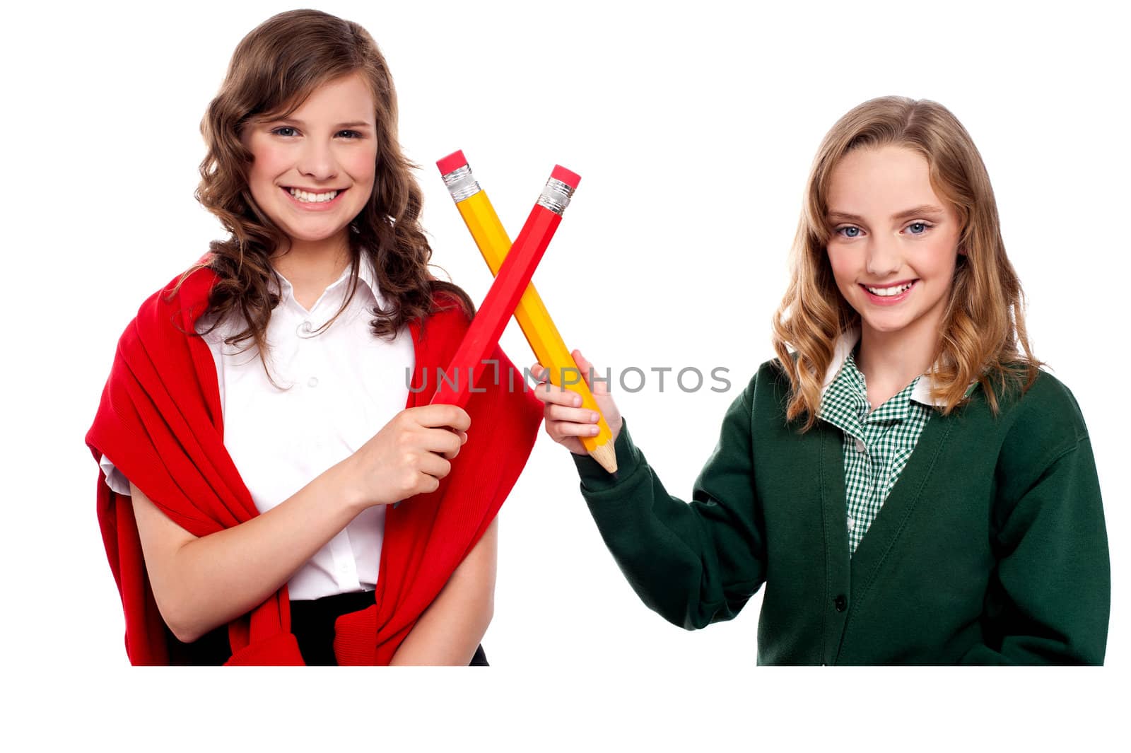 Smiling teenagers making cross sign with over sized pencils. All on white background
