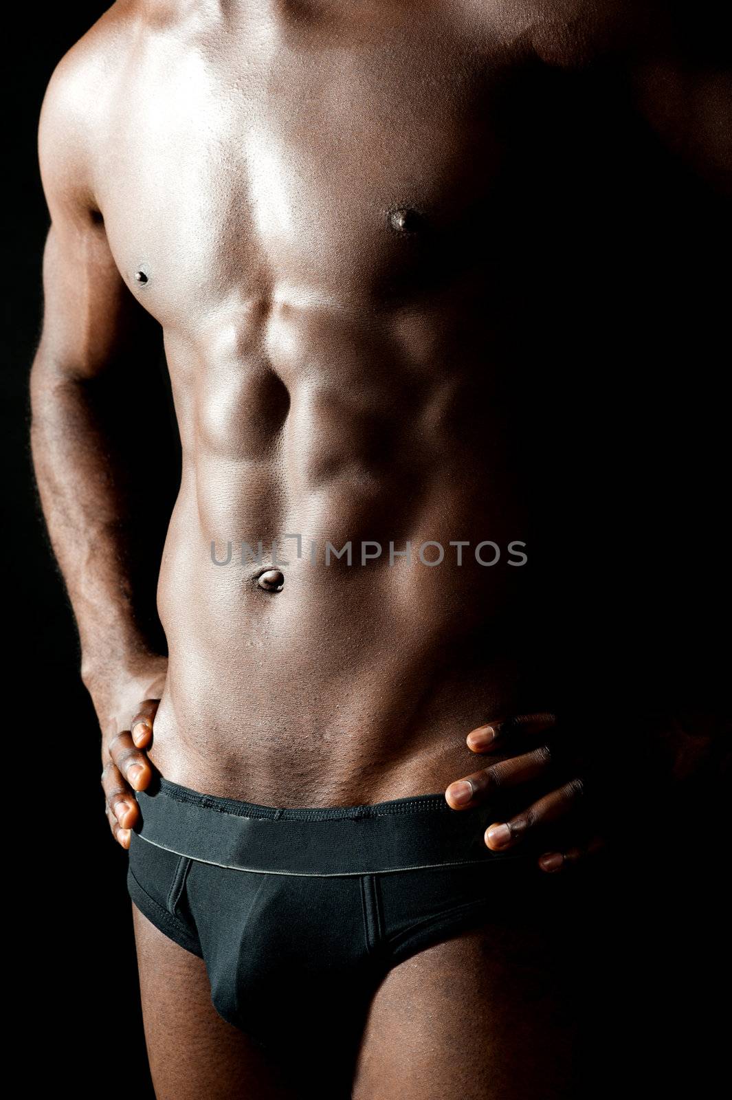 Shirtless underwear male model posing in style. Hands on waist, cropped image