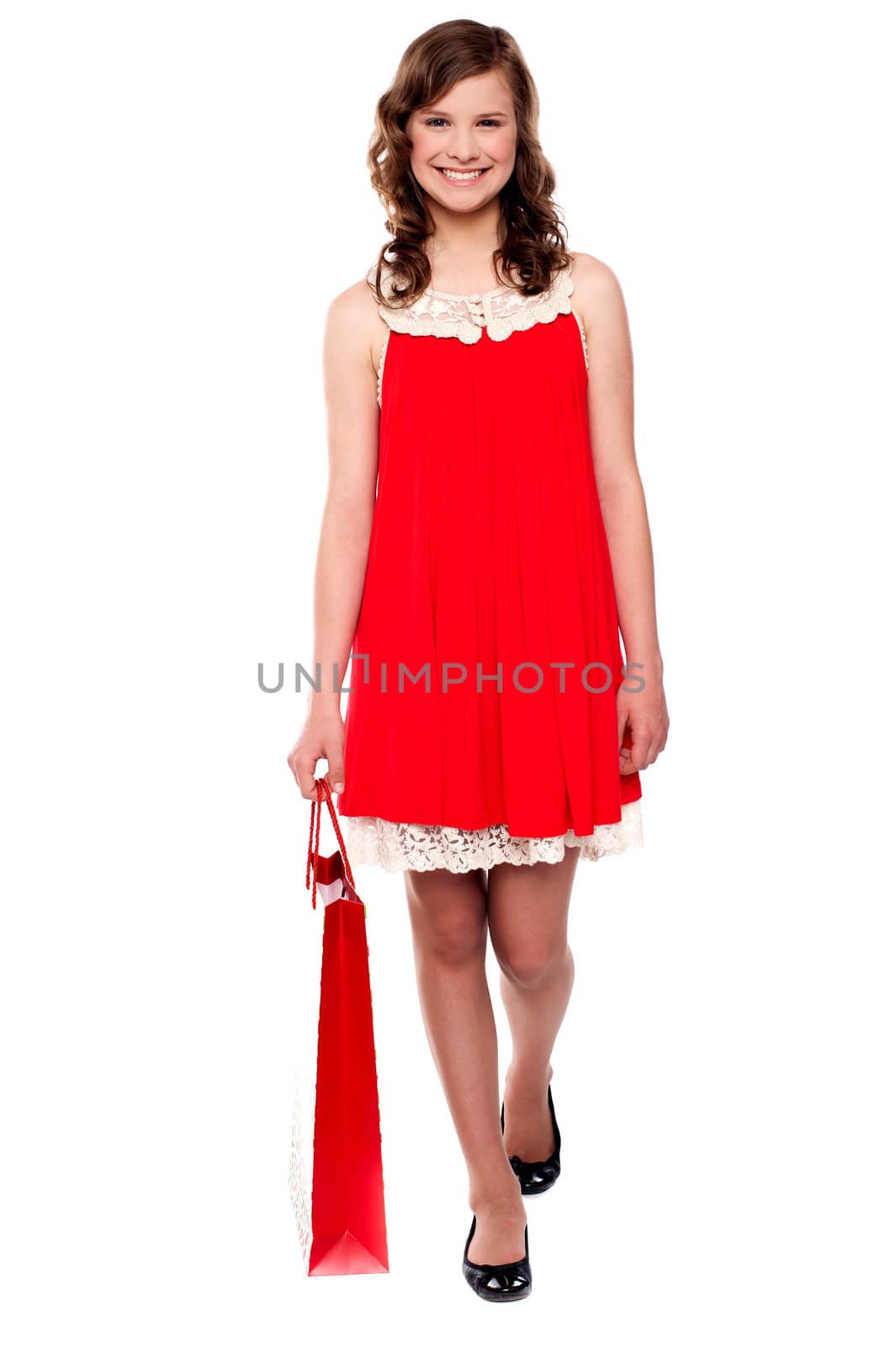 Attractive smiling teenager walking with shopping bag